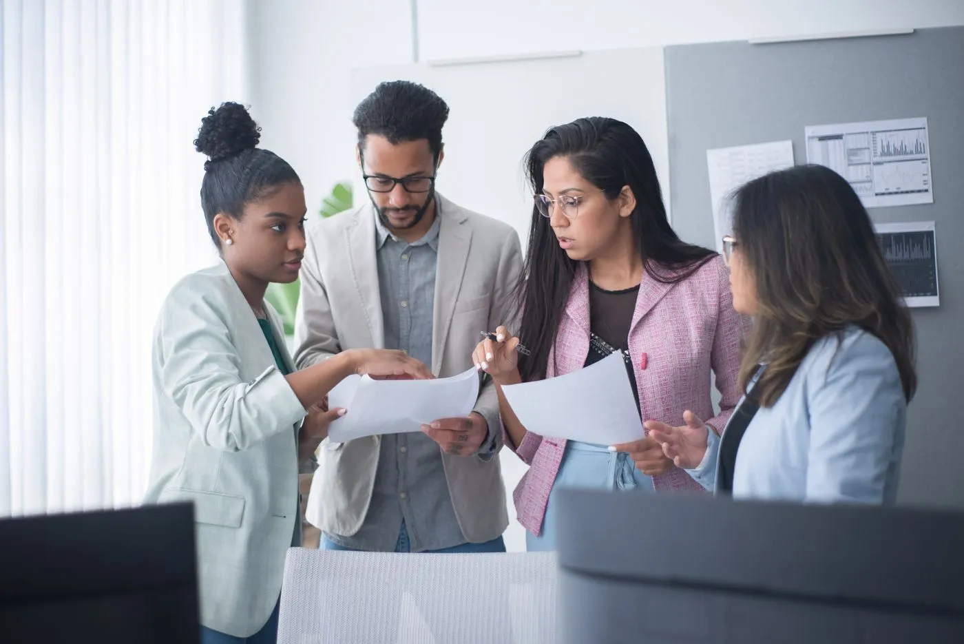 A group of professionals sharing ideas and reviewing documents together